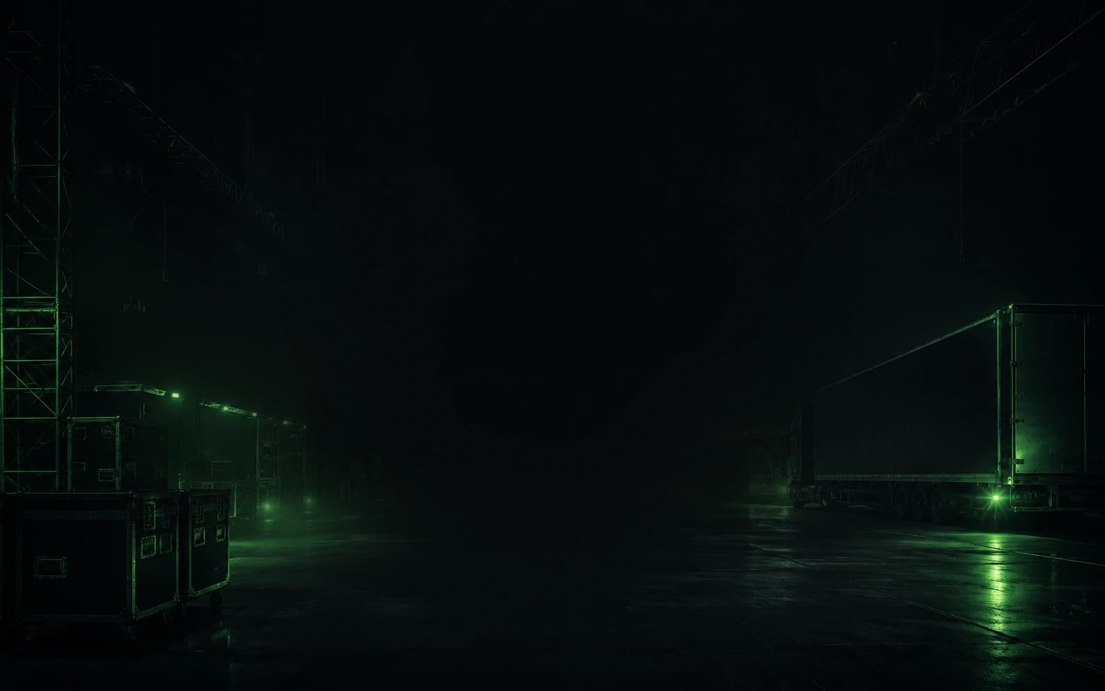 A loading yard at night: flight cases stacked at the left, a trailer backed in at the right, everything lit by a single green wash.